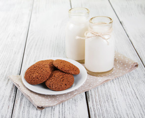 oatmeal cookies and bottles of milk