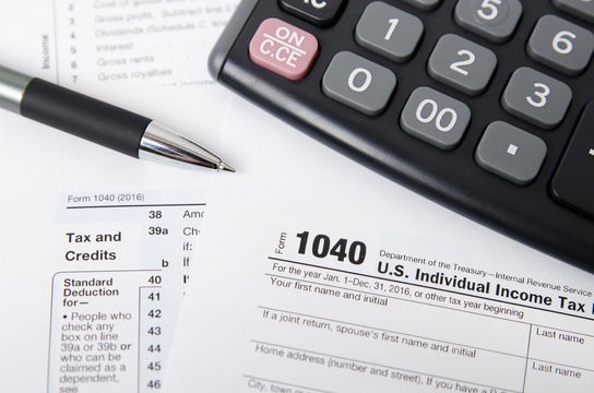 US tax form 1040 with pen and calculator