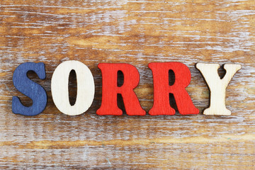 Word sorry written with colorful wooden letters
