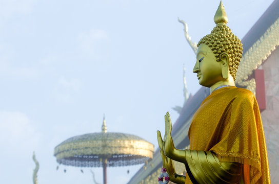Attitude of the Buddha // Buddha image standing beside the  Buddha image hall at Wat Phra That Jom Jor