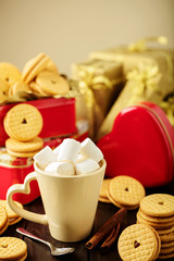 Marshmallows in a Cup with cookies with hearts out of the jam.