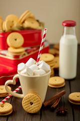 Marshmallows in a Cup with cookies with hearts out of the jam.