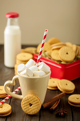 Marshmallows in a Cup with cookies with hearts out of the jam.