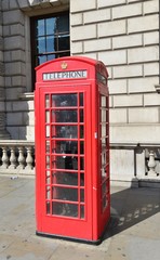 A vintage red telephone kiosk in London.
