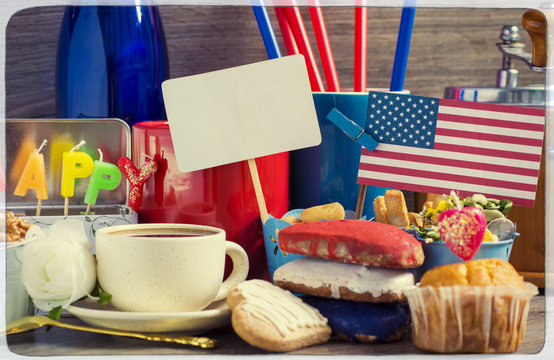 Patriotic party Concept - Heart shaped cookies color red, blue, white. Cup of coffee (tea), USA flag, decoration on old wooden table. toned filter image. space for text 