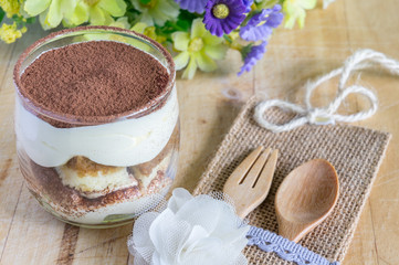 tiramisu cake homemade on wooden background. fork and spoon