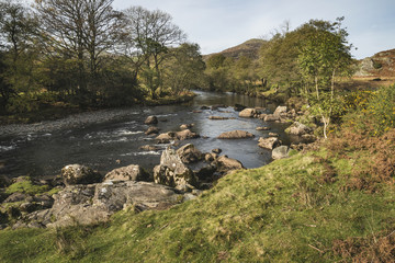 Stunning Autumn Fall landscape image of river stream in Lake Dis