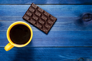 yellow cup of coffee and chocolate