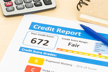 Fair credit score report with pen and calculator; document and t