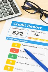 Fair credit score report with pen and calculator; document and t