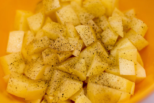 Cut raw potatoes in bowl