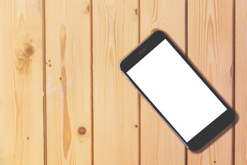 Smart phone with blank screen on wooden table background with copy space for moc up display your...