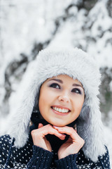 Portrait of a beautiful girl in a winter forest