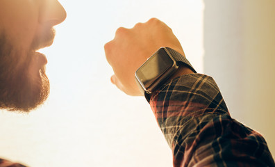 Closeup view of man using smart watch.