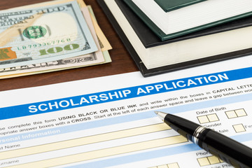Scholarship application form with pen, dollar banknote and text