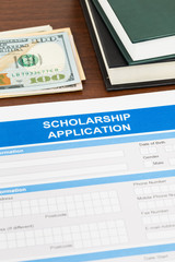 Scholarship application form with dollar banknote and text book