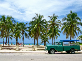 Truck converted under the bus parked on the beach. Sunny afternoon in Cuba.