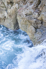 Cliff, Rocks by the sea with waves of the Mediterranean sea next