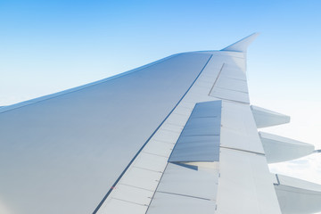 Airplane wing open speed break or  spoiler seen through window