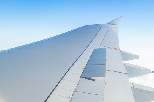 Airplane Wing Open Speed Break Or  Spoiler Seen Through Window