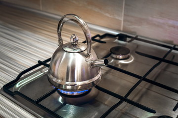 iron kettle is on gas stove