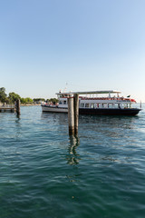 Fototapeta premium Sailboats and fishing boats at Porto di Bardolino harbor on The Garda Lake . Italy