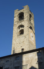 Fototapeta na wymiar Bergamo - Old city (Citta Alta). One of the beautiful city in Italy. Lombardia. The clock tower called Il Campanone (the big bell) during a wonderful blue sky.