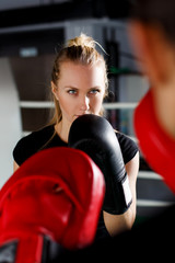 Young woman in boxing gloves