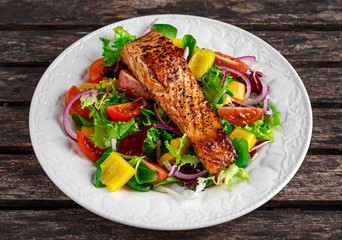 Fried Salmon steak with fresh vegetables salad. concept healthy food.