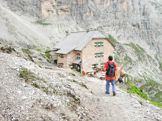 SASSOLUNGO, RIFUGIO VICENZA, ITALY, JULY 17, 2008 - Man walking on the path at "Rifugio Vicenza" in Sassolungo mountain group, Dolomites, Italy