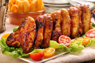Chicken wings with baked potatoes and barbecue sauce