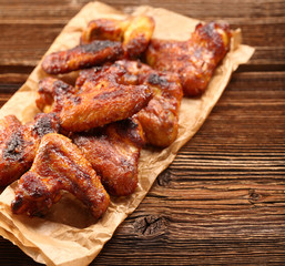 Chicken baked wings on wooden background