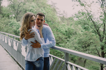 Beautiful young couple playing in a park. Summer outdoors.