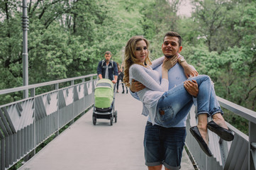 Beautiful young couple playing in a park. Summer outdoors.