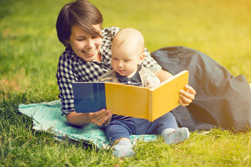 Mother with a child reading in park