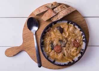 Slovak national christmas cabbage soup kapustnica with mushrooms on white background.