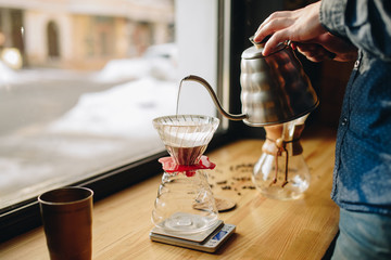 Picthers, coffee and hands on the desk near window