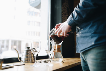 Picthers, coffee and hands on the desk near window