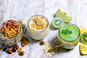 Green smoothie, oat meal and nuts - healthy, vegetarian food