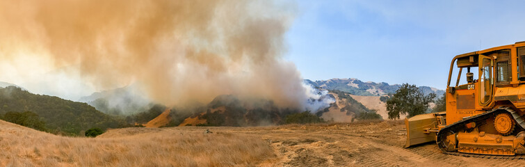 Firefighter Fighting Wildfire with Bulldozer © kcapaldo