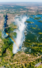 The Victoria falls is the largest curtain of water in the world (1708 m wide). The falls and the surrounding area is the National Parks and World Heritage Site (helicopter view) - Zambia, Zimbabwe - 131986129