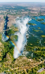 Foto op Aluminium The Victoria falls is the largest curtain of water in the world (1708 m wide). The falls and the surrounding area is the National Parks and World Heritage Site (helicopter view) - Zambia, Zimbabwe © vadim_petrakov