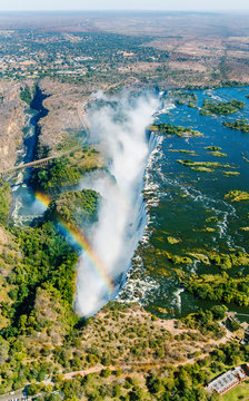 Fototapeta The Victoria falls is the largest curtain of water in the world (1708 m wide). The falls and the surrounding area is the National Parks and World Heritage Site (helicopter view) - Zambia, Zimbabwe