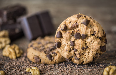 Chocolate Chip Cookies and Walnuts on Wooden Rustic Background