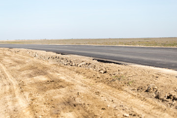 Fototapeta na wymiar new asphalt road on nature