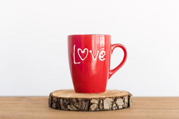Red cup of tea or coffee on the white background