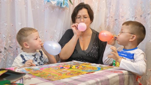 Boys inflate balloons, emotions (fear closeup,in profile)