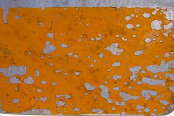 Pealing yellow paint on metal from the side of an old plane