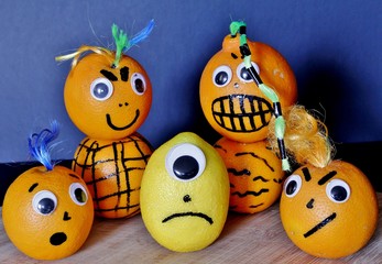 Angry oranges bullying a frightened lemon 