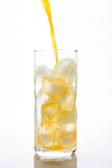 Pouring Orange Juice to the ice glass